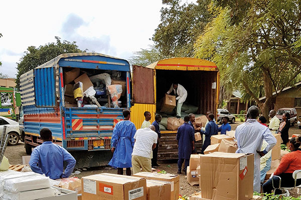 unloading medical supplies in boxes from trucks